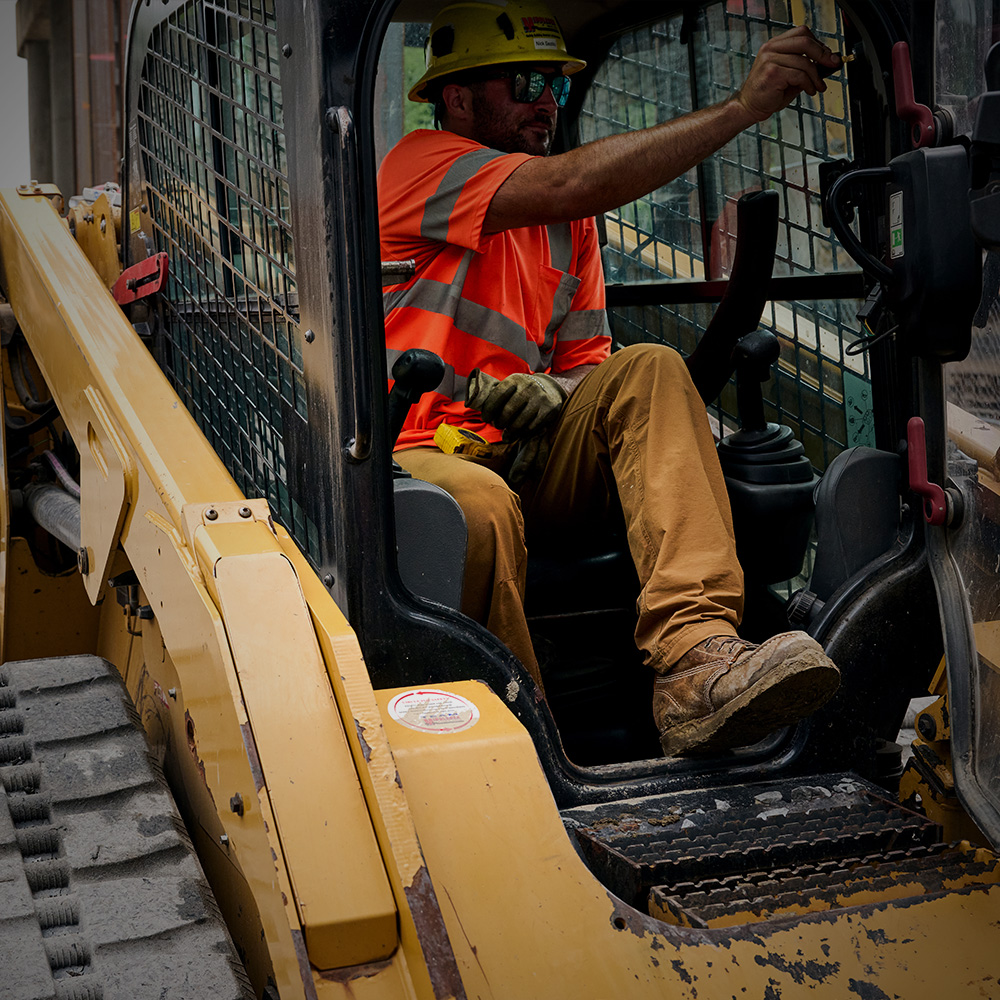 A construction worker wearing Carolina boots.